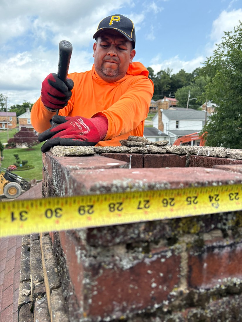 Crew measuring a chimney crown that has broken into loose pieces